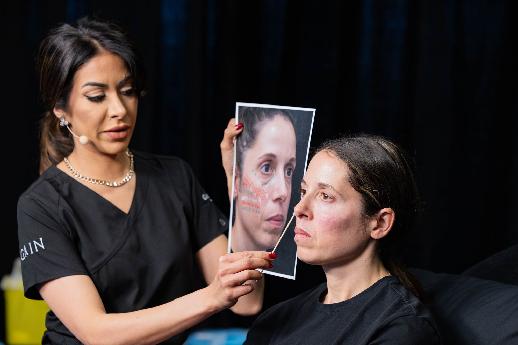 Dr Priya Chadha performing a facial assessment during an aesthetic consultation